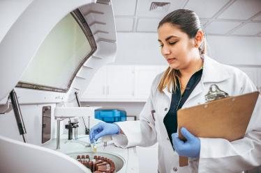 Laboratory technician operating a centrifuge at Tricare Medical Centre